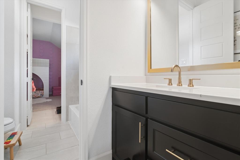 582 Broadleaf Way Haslet, TX 76052 - Photo 27 of 38 a en suite bathroom with a sink and a mirror