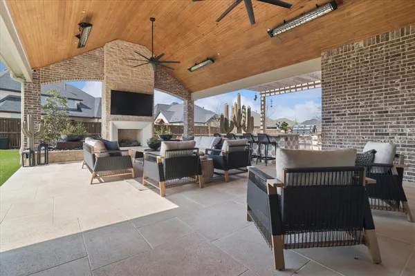 a view of a patio with dining table and chairs