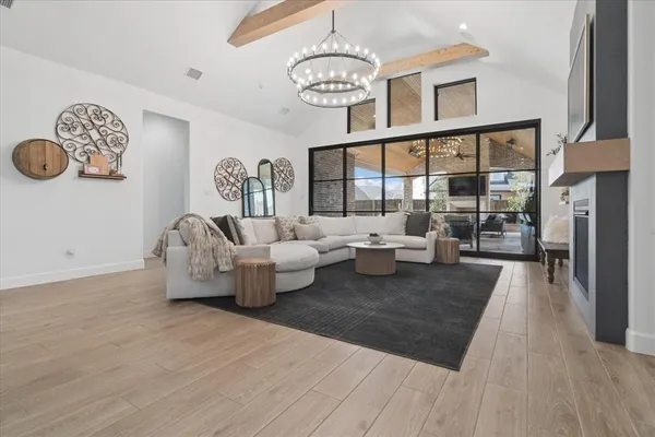 a living room with furniture large window and a table