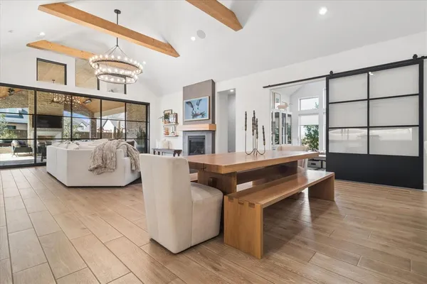a living room with furniture a large window and wooden floor