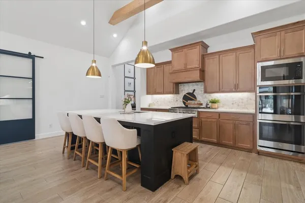 a kitchen with a sink cabinets and wooden floor