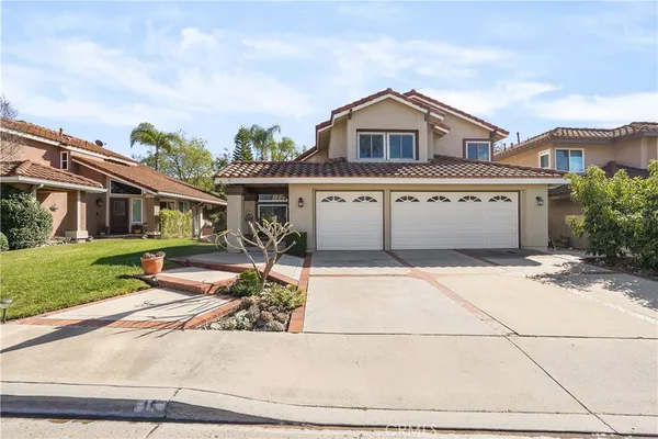 a view of a house with a patio and a yard