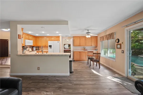 a view of washer and dryer with kitchen in the background