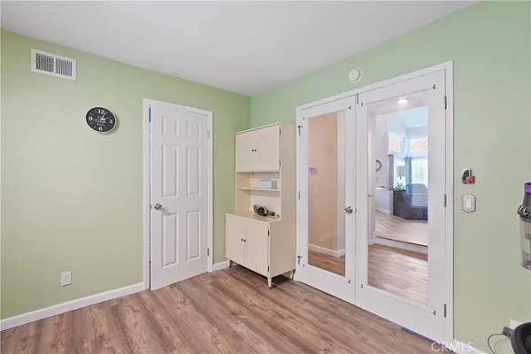 a bedroom with a bed window and a flat screen tv