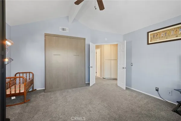 a view of walk in closet with clothes