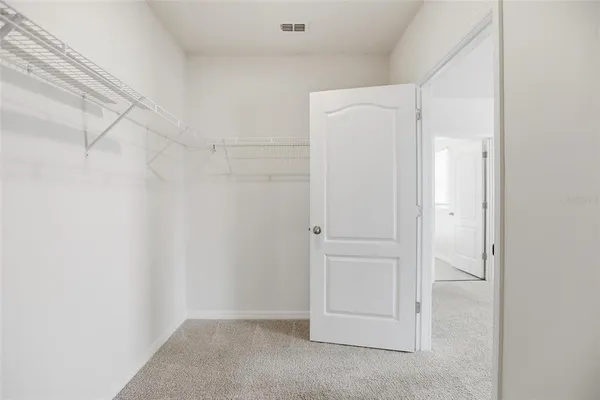 a view of an empty room and a window