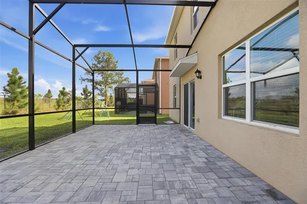 a view of a house with a big yard plants and large trees