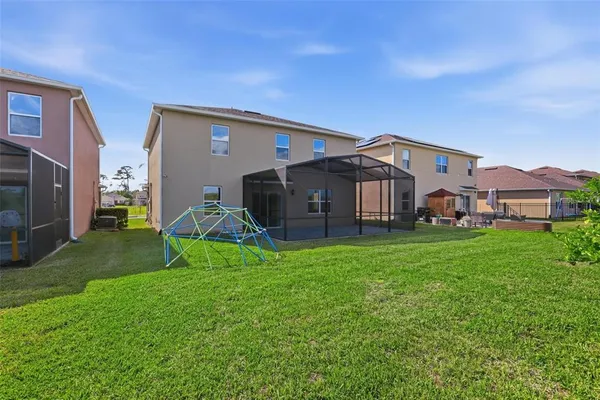 a view of a dining room with furniture chandelier and glass door
