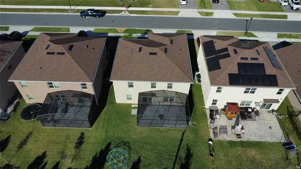 a living room with furniture a chandelier and a large window