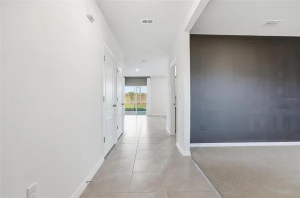 a view of an empty room and glass door