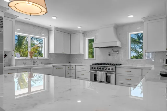 a kitchen with stainless steel appliances granite countertop a stove a sink and a refrigerator