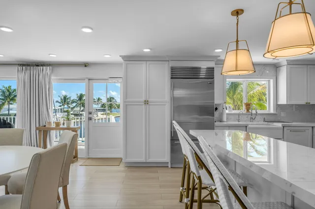 a bedroom with furniture a large window and a chandelier