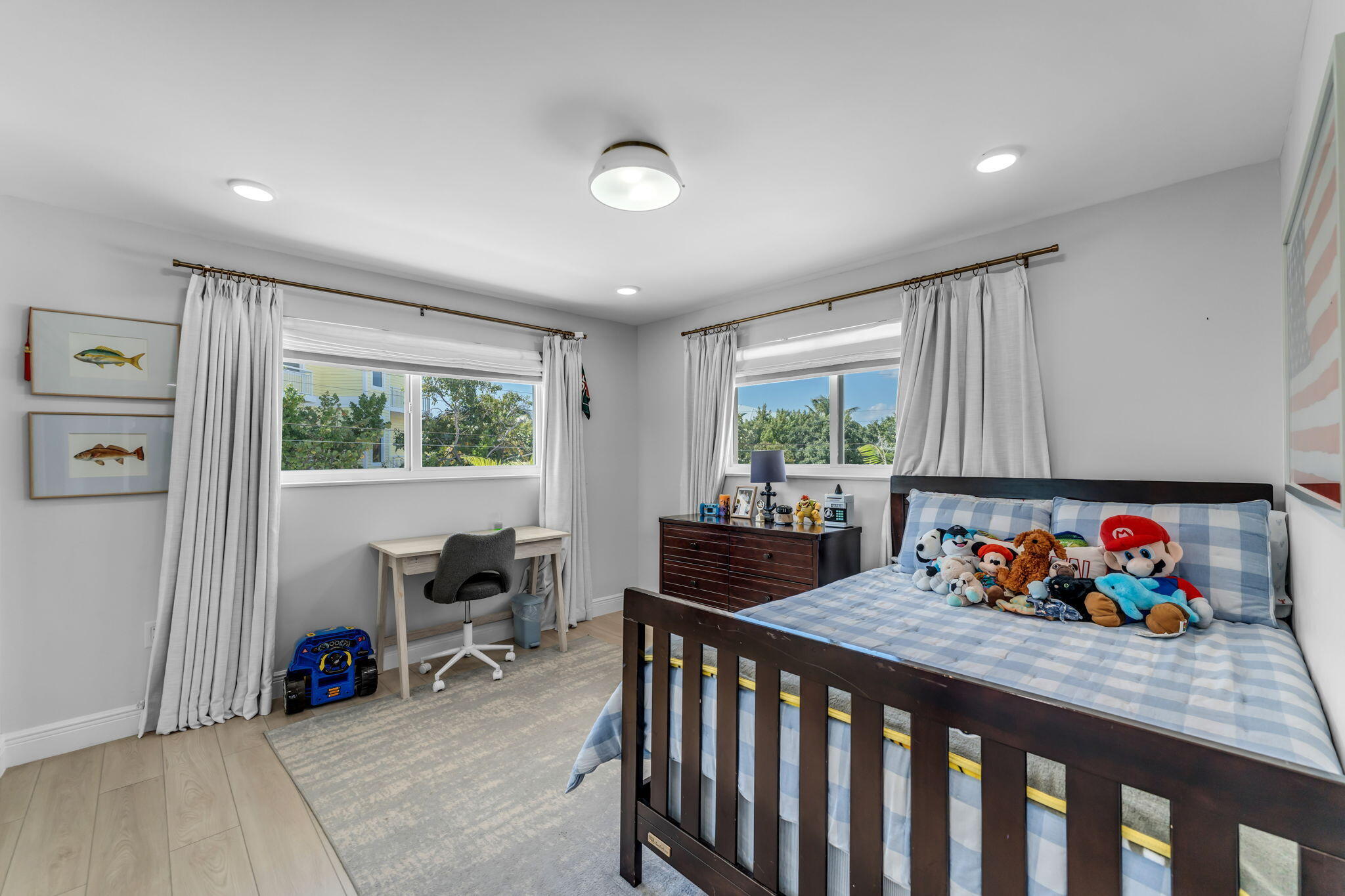 17 Poisonwood Road Key Largo, FL 33037 - Photo 15 of 57 a bedroom with furniture a large window and a chandelier