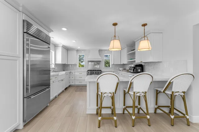 a kitchen with cabinets stainless steel appliances and window