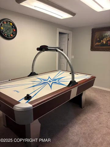 a room with pool table and a wall