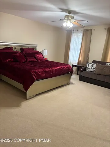 a spacious bedroom with a bed and a chandelier