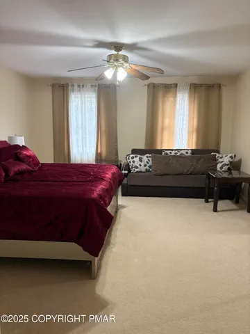 a bedroom with a bed mirror and window
