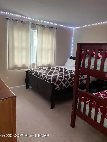 a bed sitting in a bedroom next to a window