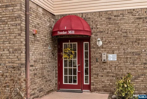 a front view of a building with a door and a window