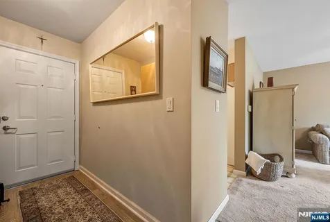 a view of a livingroom with wooden floor and a bedroom