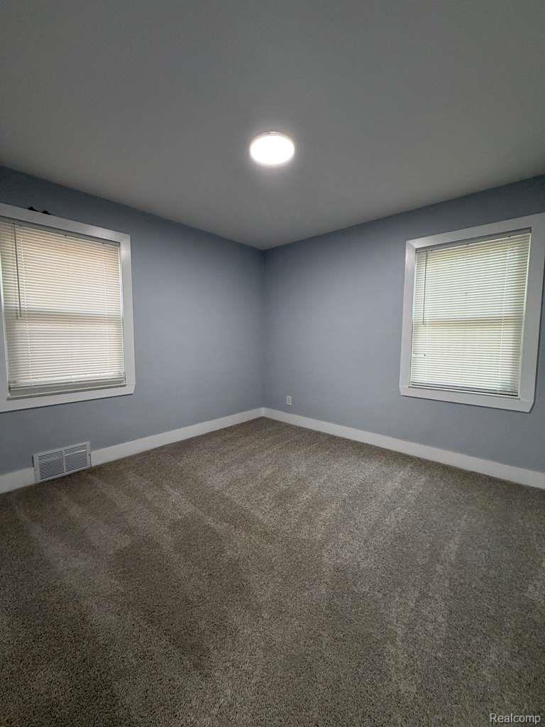 7416 Heyden Detroit, MI 48228 - Photo 7 of 16 Spare room featuring dark colored carpet and baseboards