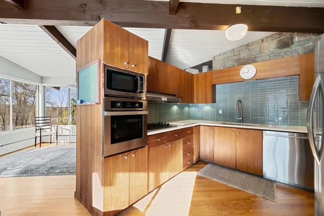 a kitchen with stainless steel appliances granite countertop a refrigerator and a sink