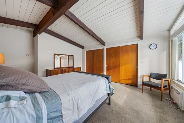 a spacious bedroom with a bed and a window