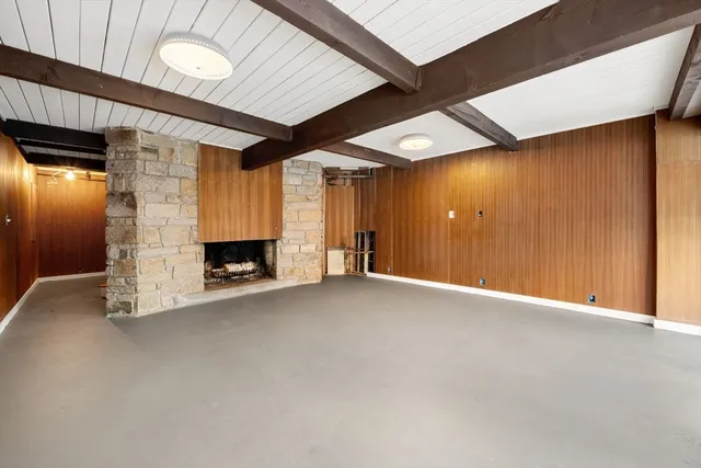 a view of an empty room with a fireplace