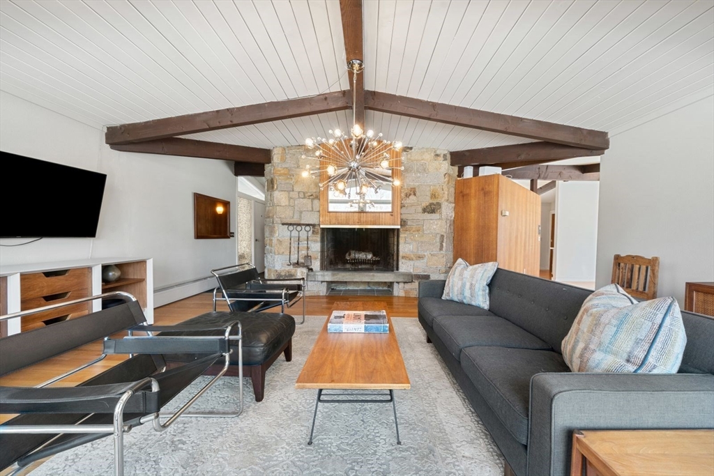 15 Westview Drive Sutton, MA 01590 - Photo 8 of 39 a living room with furniture a flat screen tv and a fireplace