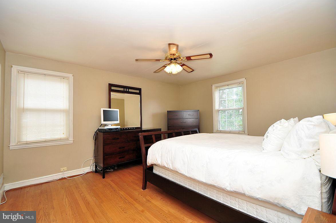 408 Greenlow Road Baltimore, MD 21228 - Photo 12 of 20 a bedroom with a bed chandelier and a window