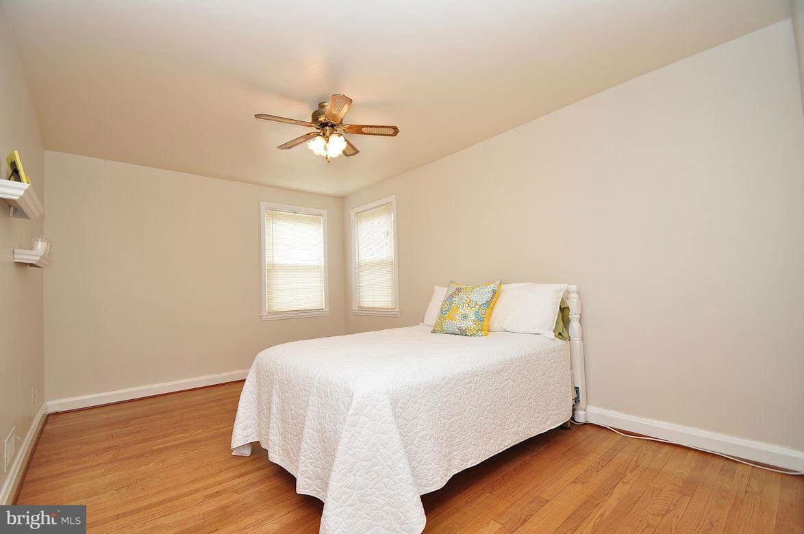 408 Greenlow Road Baltimore, MD 21228 - Photo 14 of 20 a bedroom with a bed and wooden floor