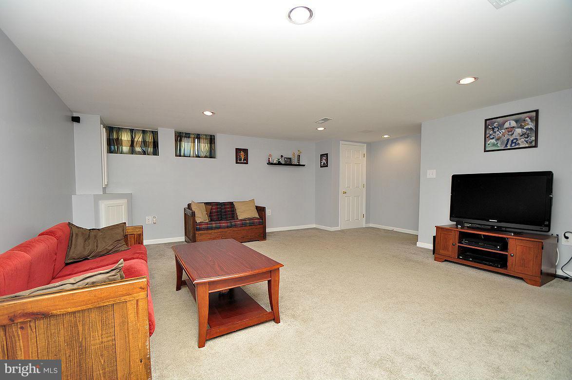 408 Greenlow Road Baltimore, MD 21228 - Photo 15 of 20 a living room with furniture and a flat screen tv