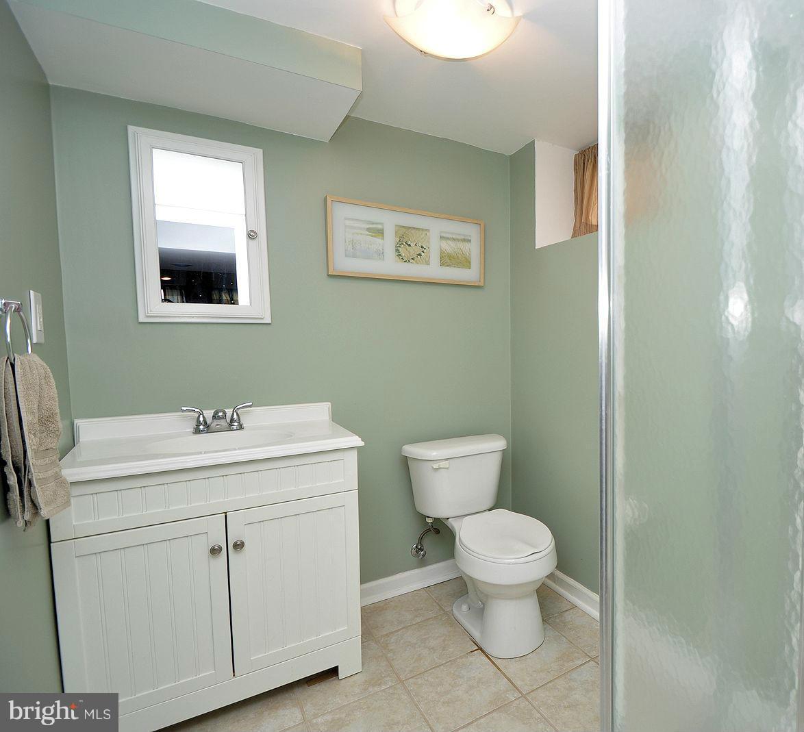 408 Greenlow Road Baltimore, MD 21228 - Photo 19 of 20 a bathroom with a toilet sink and mirror