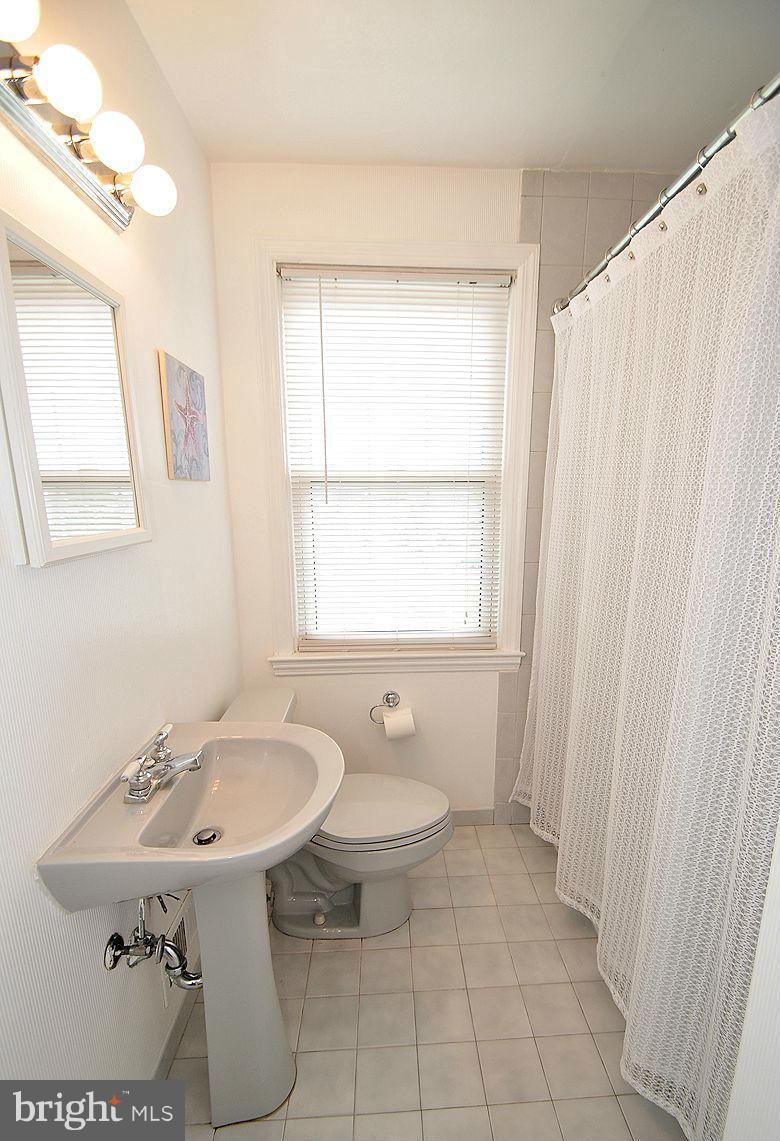 408 Greenlow Road Baltimore, MD 21228 - Photo 20 of 20 a bathroom with a sink toilet and mirror