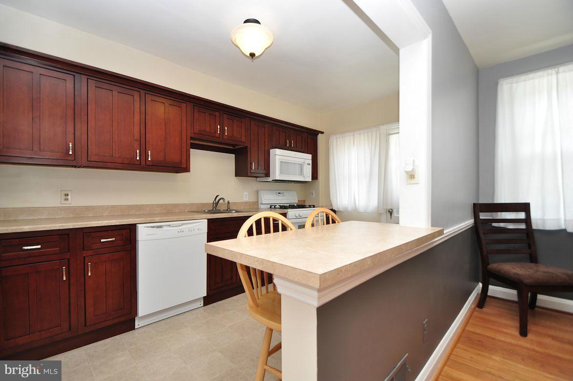 408 Greenlow Road Baltimore, MD 21228 - Photo 10 of 20 a kitchen with a stove a sink and a refrigerator