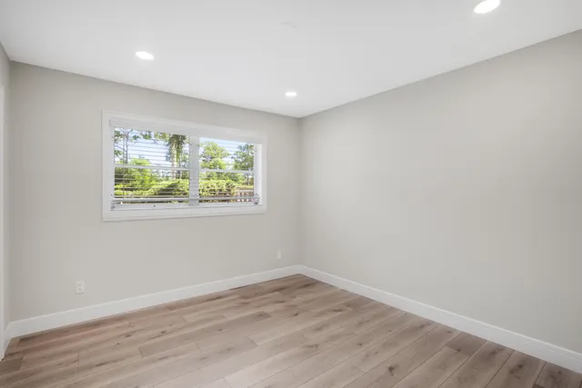 a bathroom with a granite countertop sink toilet a mirror and shower