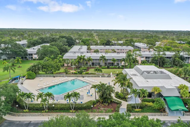 an aerial view of residential houses with outdoor space and city view