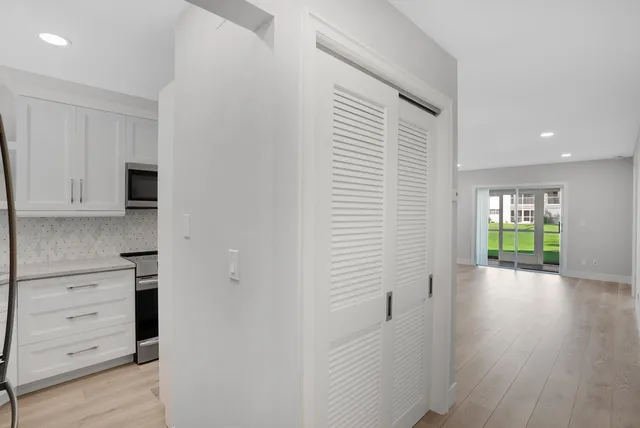 a view of hallway with wooden floor