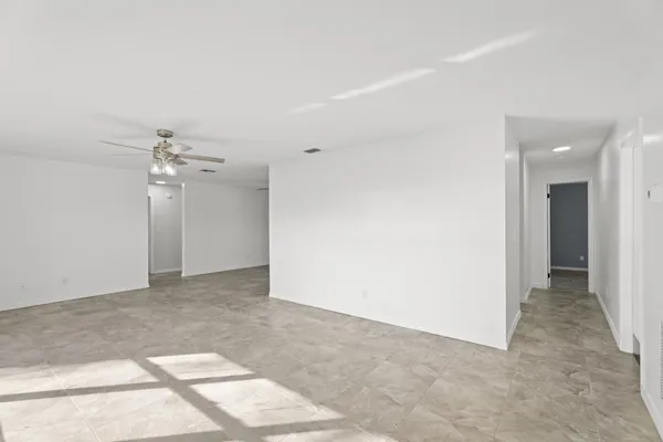 a view of a kitchen with refrigerator and a ceiling fan