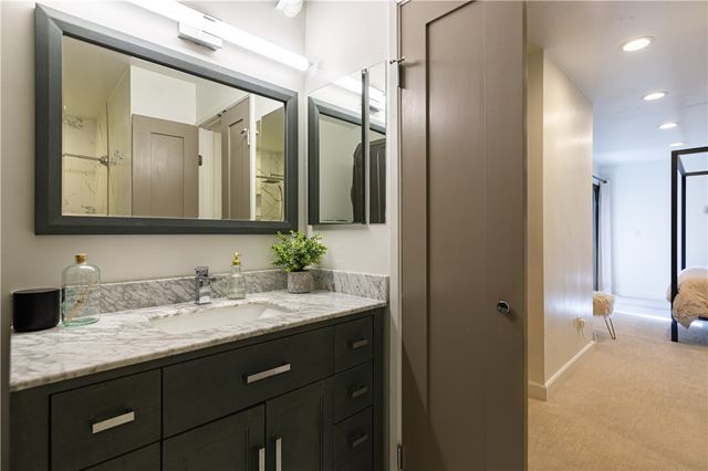 a bathroom with a double vanity sink and mirror