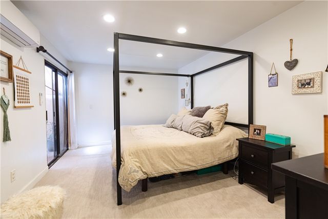 a bedroom with a bed and a table