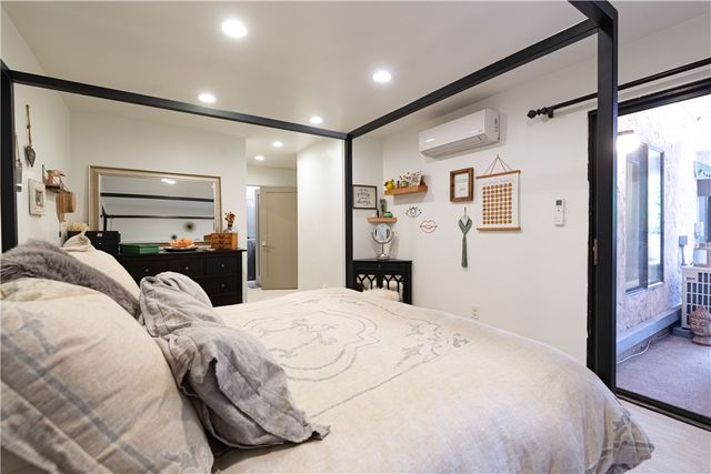 a bed room with a bed and a mirror