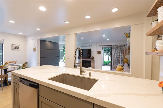 a large kitchen with a sink and a refrigerator