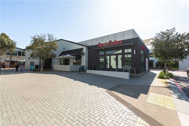 a view of a house with a floor to ceiling windows and a basket ball poll