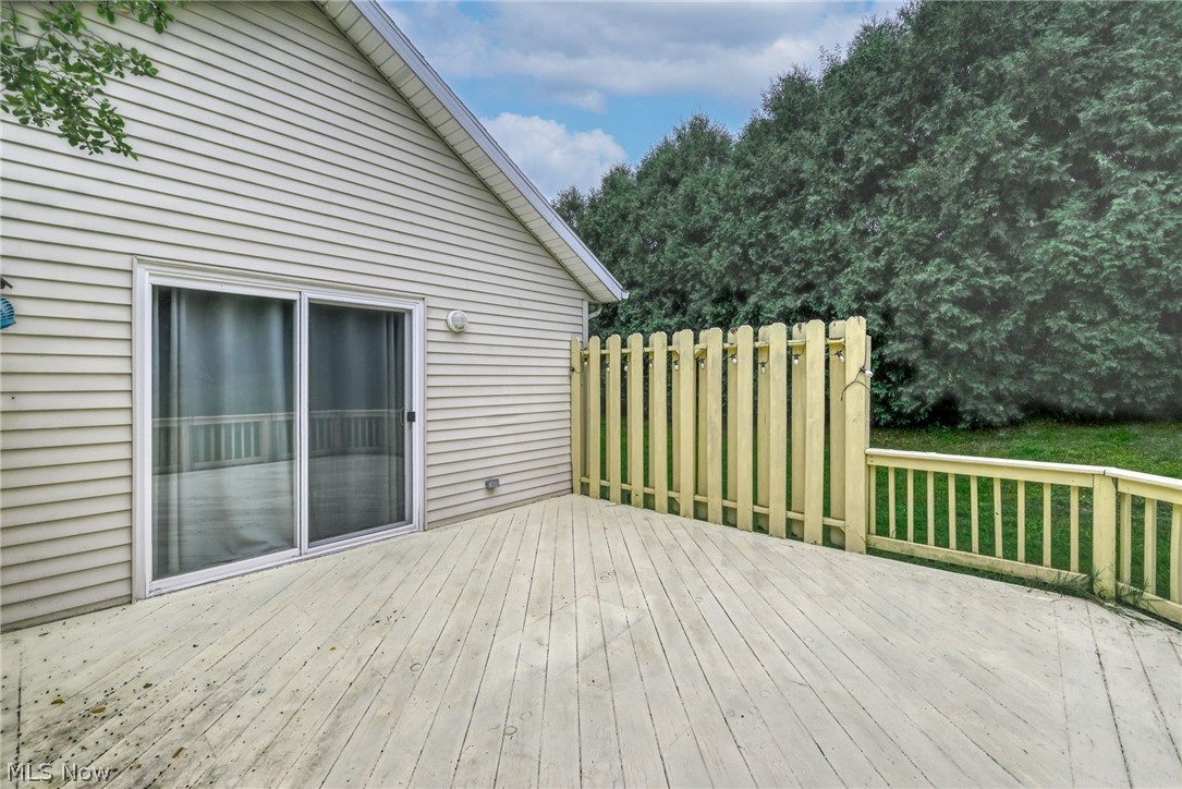 5203 Cline Road Kent, OH 44240 - Photo 30 of 35 Expansive outdoor deck with wood plank flooring, privacy fencing, and wood railing