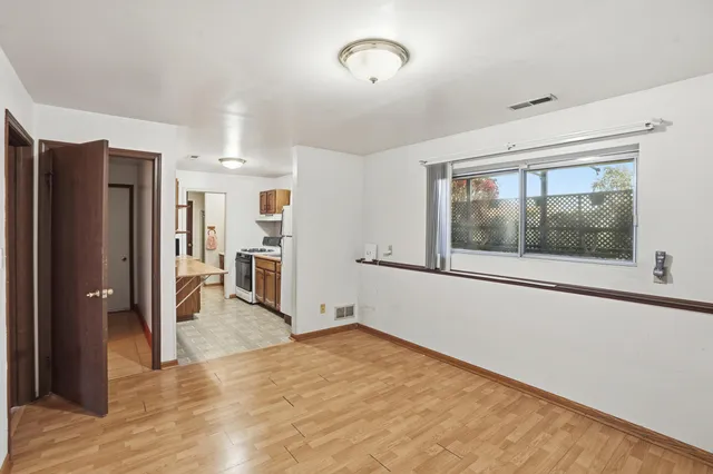 a view of a kitchen with a refrigerator a sink and a window