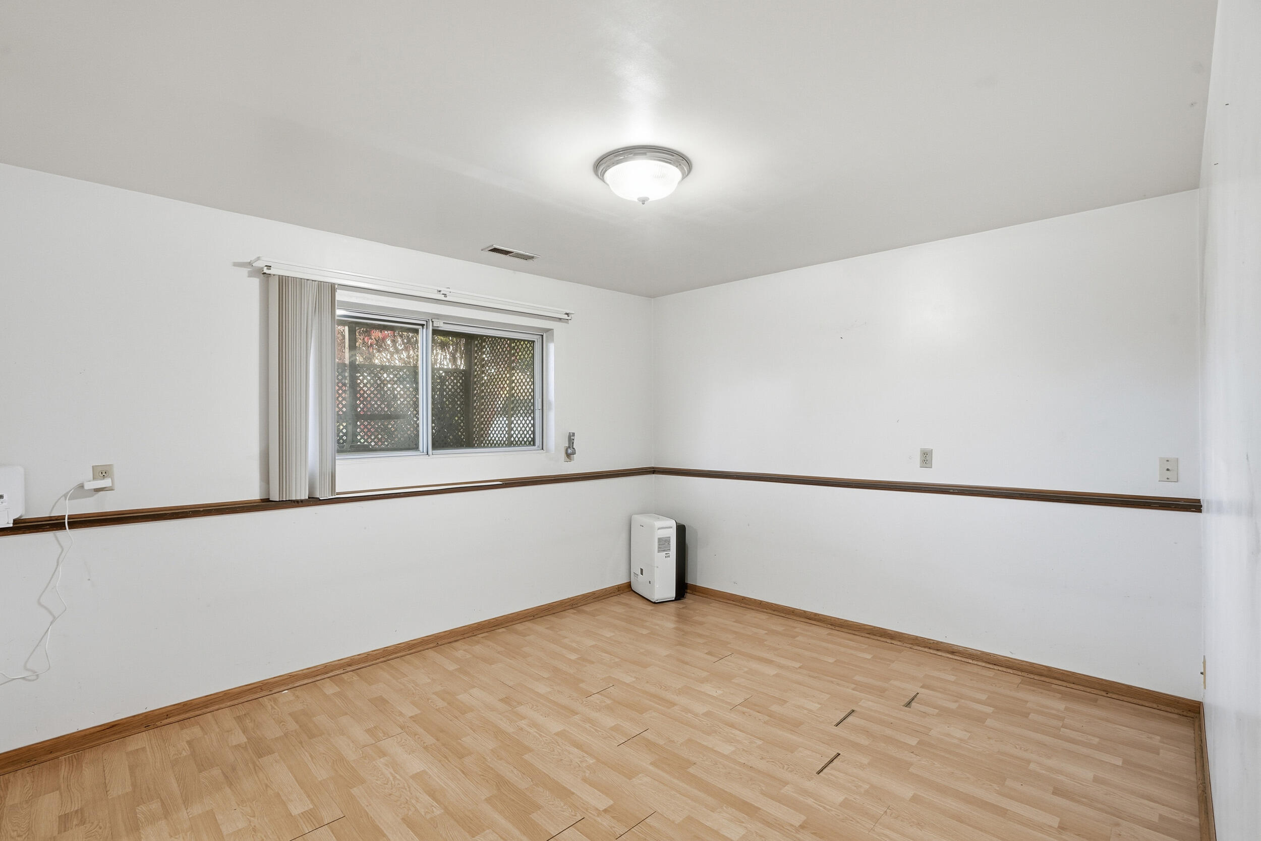 4142 Augusta Drive Crown Point, IN 46307 - Photo 19 of 24 a view of an empty room with wooden floor and a window