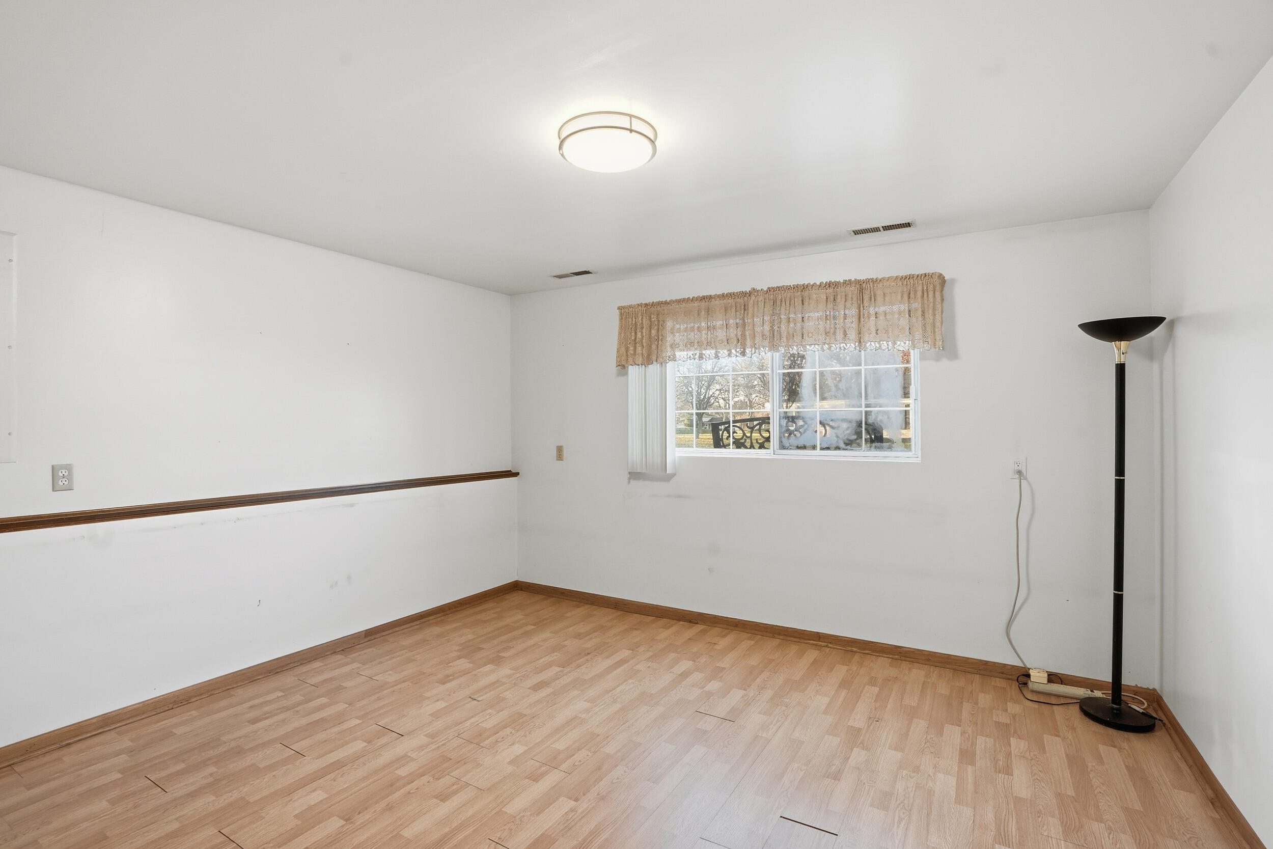 4142 Augusta Drive Crown Point, IN 46307 - Photo 20 of 24 a view of an empty room with wooden floor and a window