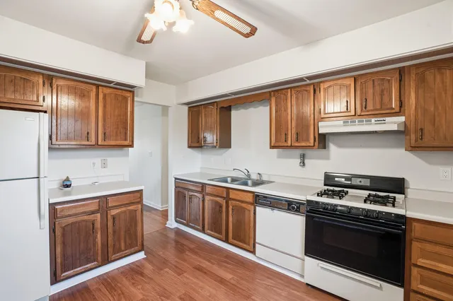 a kitchen with stainless steel appliances a stove sink and cabinets