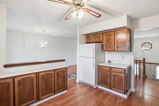 a hallway with sink a mirror a washer and dryer